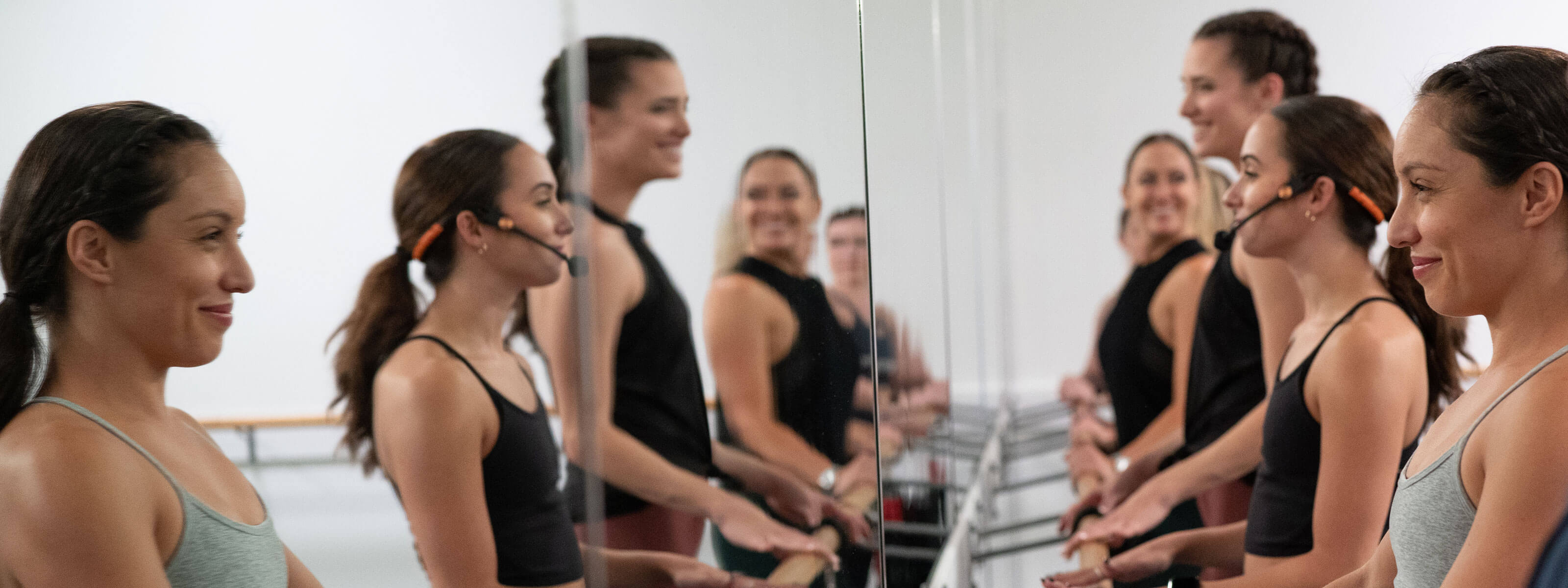 Pure Barre instructor leading group doing barre exercises